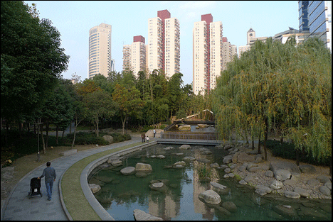Photo: A pretty park with towers in the distance.