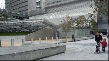 Photo: a couple of people in the harsh plaza in front of the San Francisco Federal Building.