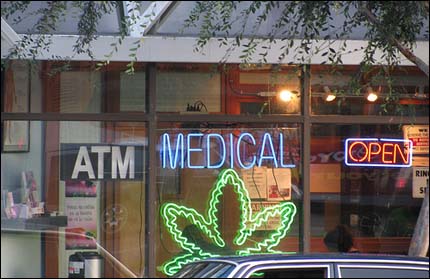 Photo: A neon pot leaf sign in a dispensary.