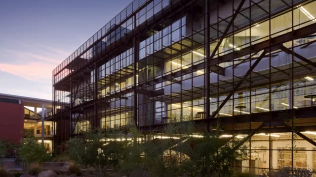 University of Arizona Campus building with glass windows and dark railings taken during dusk