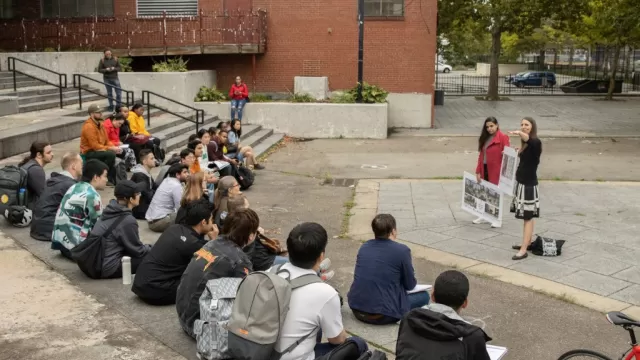 Boston University Campus stairs with students sitting and watching a presentation