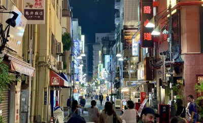 Uenookachimachi Central Street in Taitō City, Tokyo, a lively pedestrian-friendly street known for its neon glow, narrow storefronts, and energetic nighttime vibe.