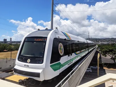 A white train on a raised rail line