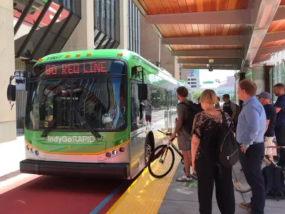 Passengers line up to board a bus at a bus rapid transit station in Indianapolis.