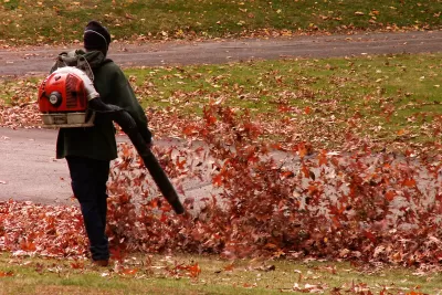A groundskeeper blows autumn leaves in the Homewood Cemetery, Pittsburgh