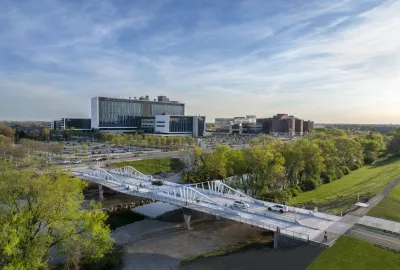 Aerial view of Fall Creek bridge in Indianapolis with bike lanes and walking paths.