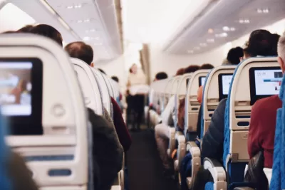 Airplane aisle with seated passengers