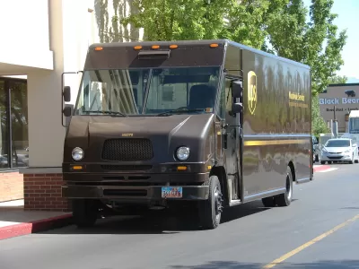 UPS delivery truck parked by urban sidewalk