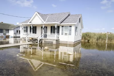White house surrounded by several inches of tidal floodwaters.