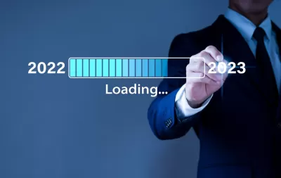A computer generated graphic of a man loading 2022, approaching 2023.