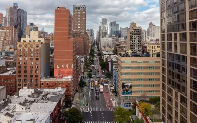 A view of NYC sky rises under a cloudy sky.