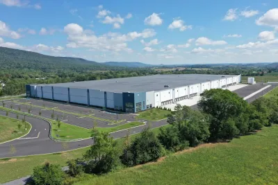 A large warehouse from the outside with parking lot exterior