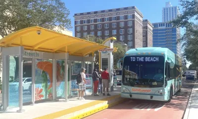 Blue SunRunner bus in Tampa Bay at station with dedicated bus lane, marquee reads "To the beach."