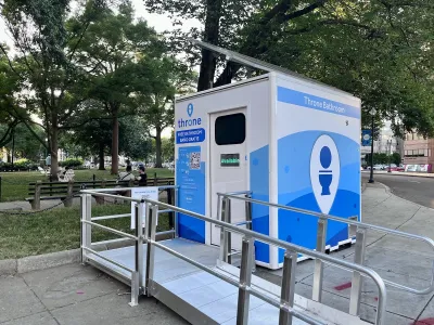White and blue modular Throne public restroom outdoors in Washington DC.