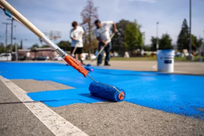 Paint roller coating basketball court with blue cooling coating
