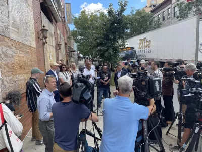 A large group of press and media surround New York City mayoral candidate Eric Adams. 