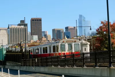 Boston Red Line train with skyline in background.