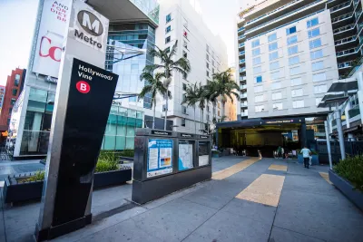 Entrance to subterranean Hollywood/Vine Metro station in Los Angeles, California surrounded by tall apartment buildings.