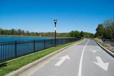 Bi-directional bike trail next to small lake in Baltimore, Maryland.