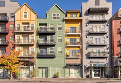Colorful five-story condo buildings with retail on ground floor in Gresham, Oregon.