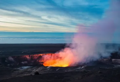 Lava visible in crater with steam coming out in Hawaii.