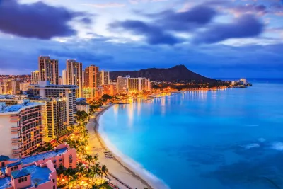 Aerial view of Honolulu, Hawaii coastline at dusk.