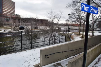 Flint River with blue sign on post in winter.