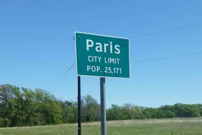 Green Paris Texas city limit sign with population.