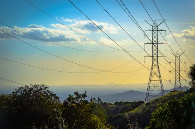 Power lines at golden hour with downtown Los Angeles in far background.