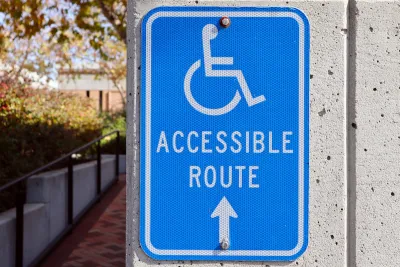 Blue and white "Accessible Route" sign with wheelchair logo.