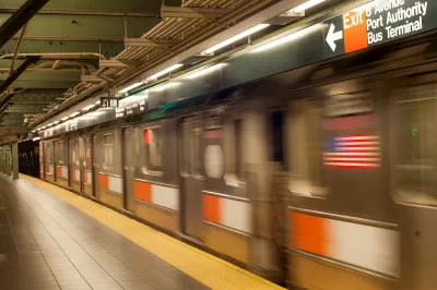 Blurred NYC subway train passing by empty platform with yellow strip.