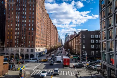 New York City street with some traffic with red brick buildings on either side