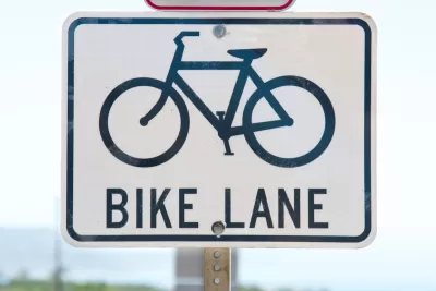 Close-up of 'bike lane' road sign with bike logo