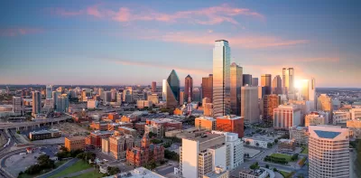 View of downtown Dallas, Texas skyline with skyscrapers against twilight sky.