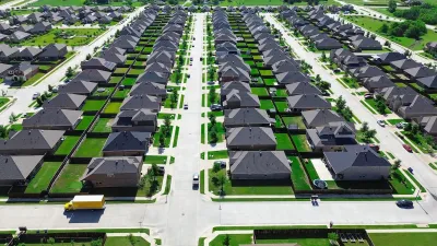 Single-family homes with green lawns in suburban Princeton, Texas.