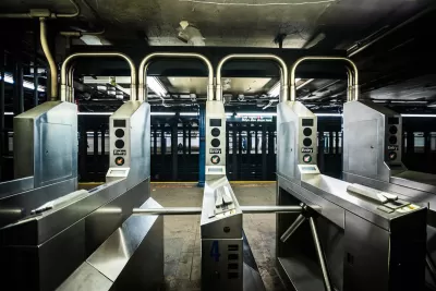 Silver turnstiles at a subterranean subway station