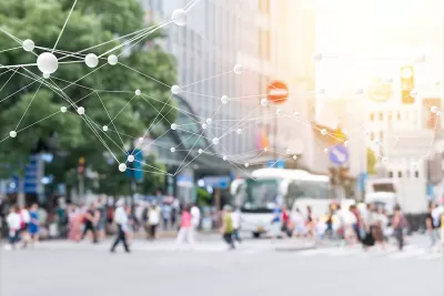 Blurred image of pedestrians on busy street with 'smart city' network rendering superimposed.
