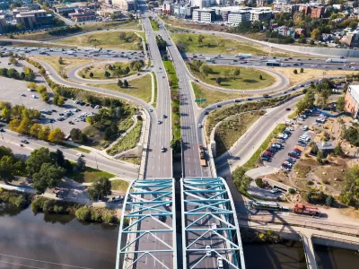 Aerial view of wide roadway and arc bridge in Denver, Colorado.