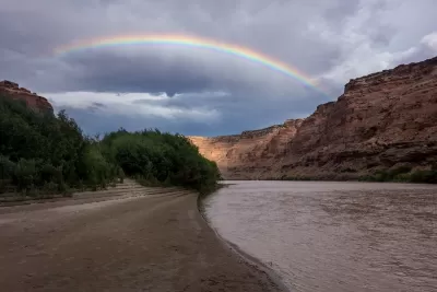 Rainbow over red rocks and river in Utah's Labyrinth Canyon.