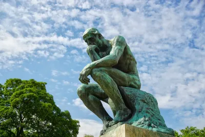 The Thinker sculpture by Rodin installed outdoors.