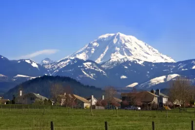 Homes in rural area with snowy Mt. Rainier in background in Washington state.