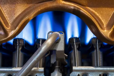 Close-up of blue flame in gas-powered water heater.