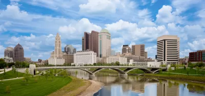 Skyline of Columbus, Ohio with bridge and river.