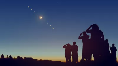 Sillhouettes of group of people watching solar eclipse.