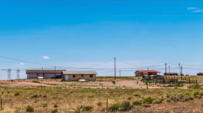 View of three manufactured homes on a hill somewhere in Navajo Nation