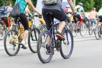 Large group of cyclists on city street.