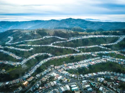 Aerial view of homes on green hillsides in Daly City, California.