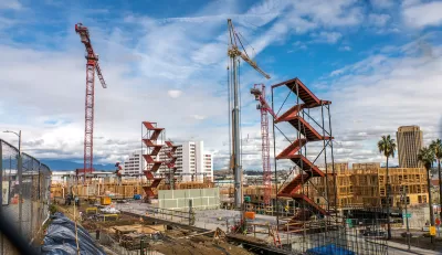 Large construction site with red staircases and cranes near downtown Los Angeles, California.