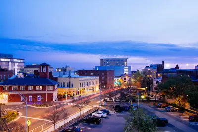View of low-rise buildings in downtown Durham, North Carolina at sunset.