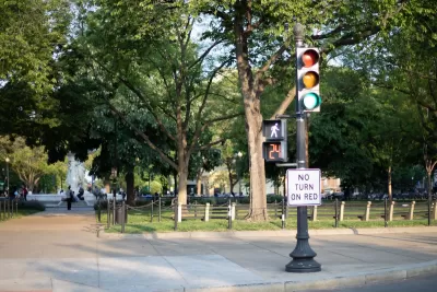 "No turn on red" sign on signpost with pedestrian stoplight.